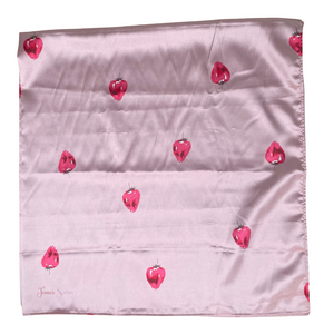 Pink fabric with red strawberry pattern on a white background