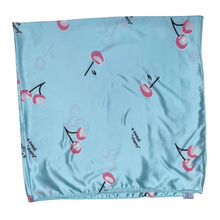 Load image into Gallery viewer, Light blue fabric with cherry pattern and text on a white background

